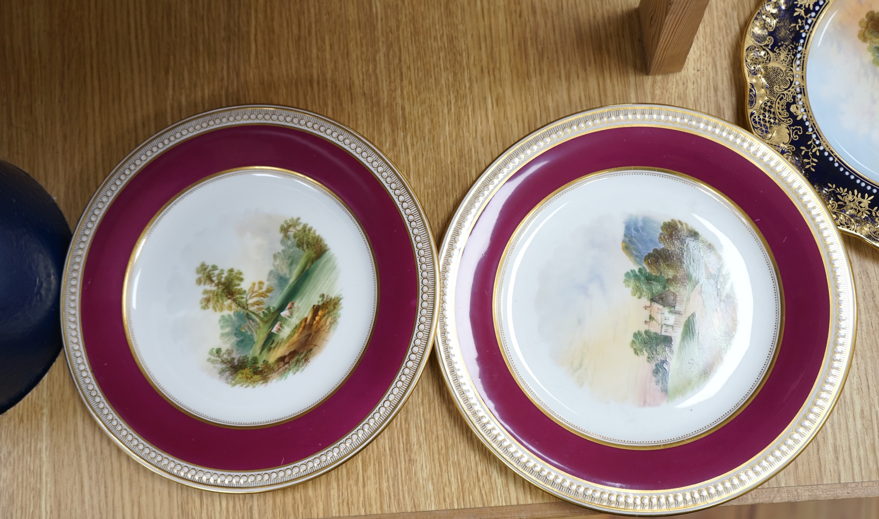 A collection of English porcelain plates, highlights include a Royal Doulton fruit painted cabinet plate signed F Harper, a Royal Worcester flower painted cabinet plate signed E Phillips, and Aynsley plate painted with a